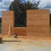 A rammed earth window section between two walls